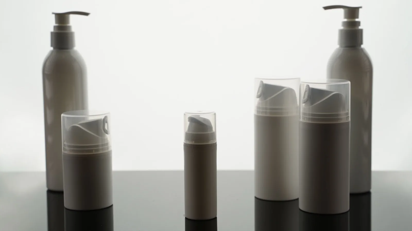 Empty cosmetic containers arranged for a neutral product-labeling concept.