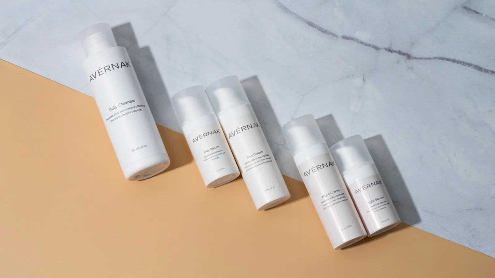 Unbranded skincare containers arranged in a neutral still life.