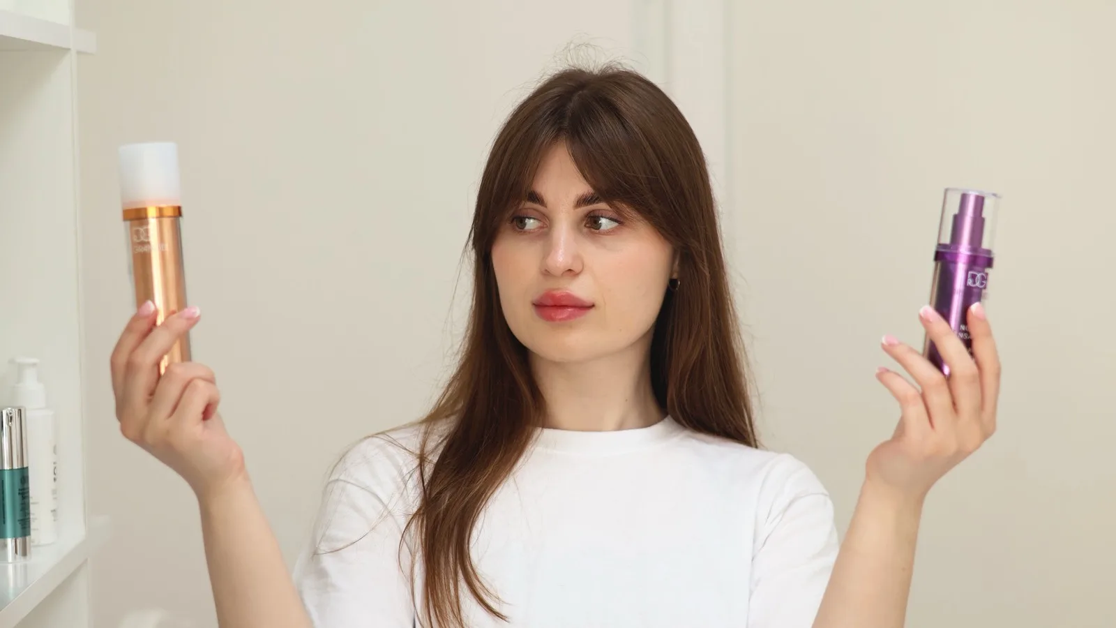 A person comparing two skincare products while deciding what to use.