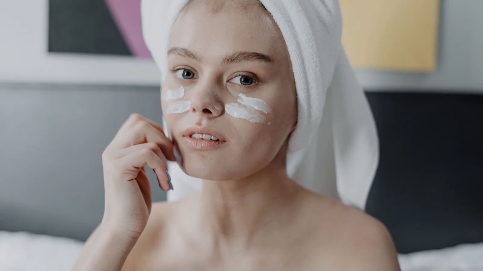 A person applying moisturizer as part of a simple night skincare routine.