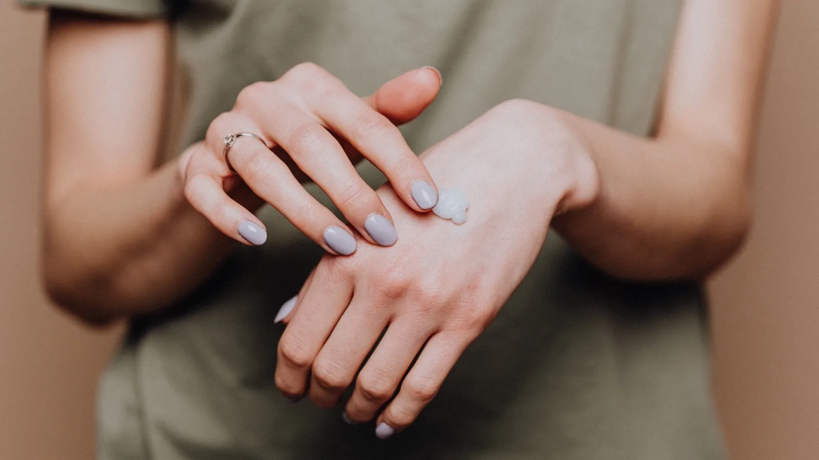 A person gently applying moisturizer as part of a skincare routine.