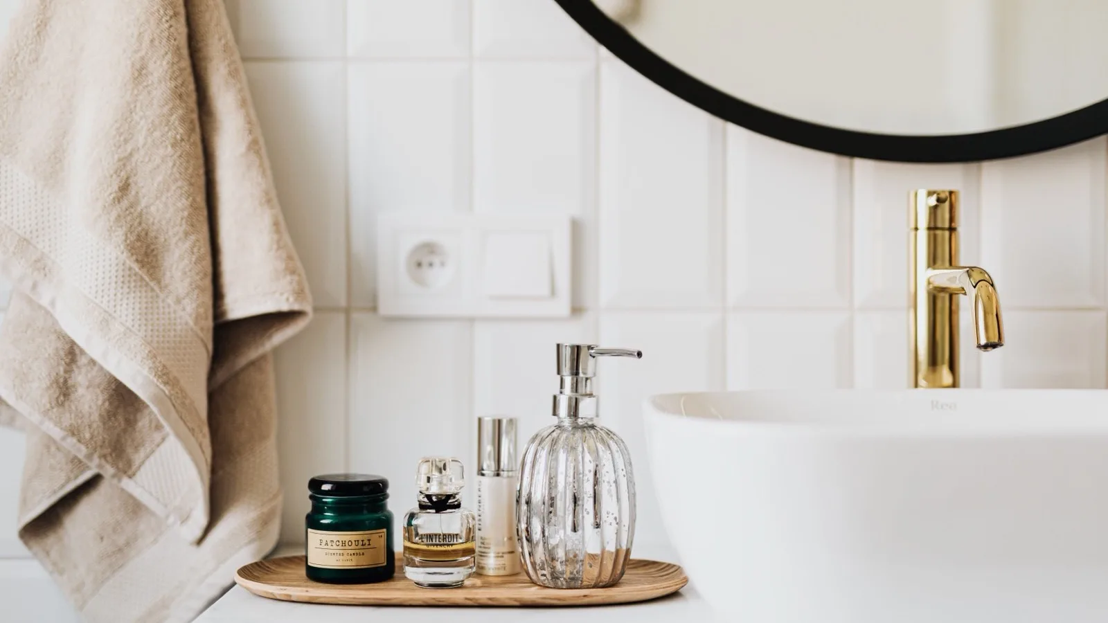 Skincare products arranged near a bathroom sink.