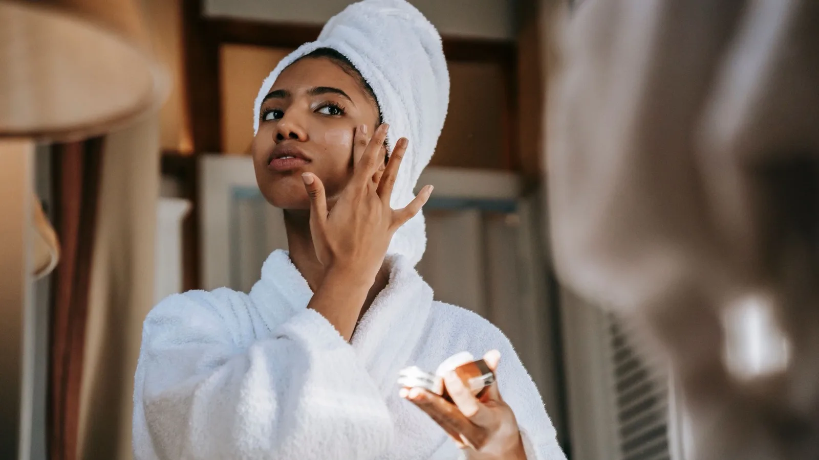 A person applying moisturizer as part of a sensitive-skin routine.