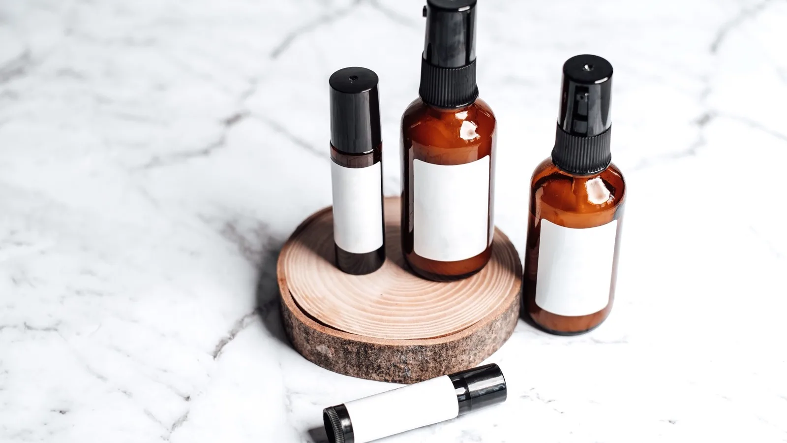 Unbranded skincare bottles arranged for comparing product ingredients.