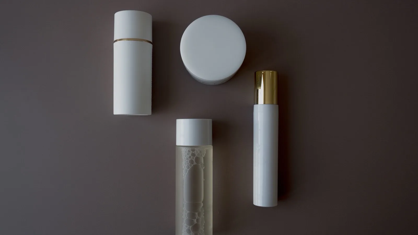 Skincare bottles arranged for comparing product labels.