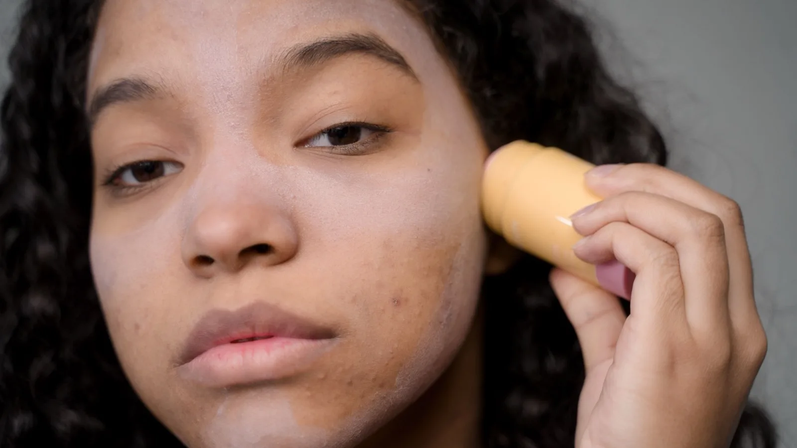 A woman considering skincare as part of a calm routine.